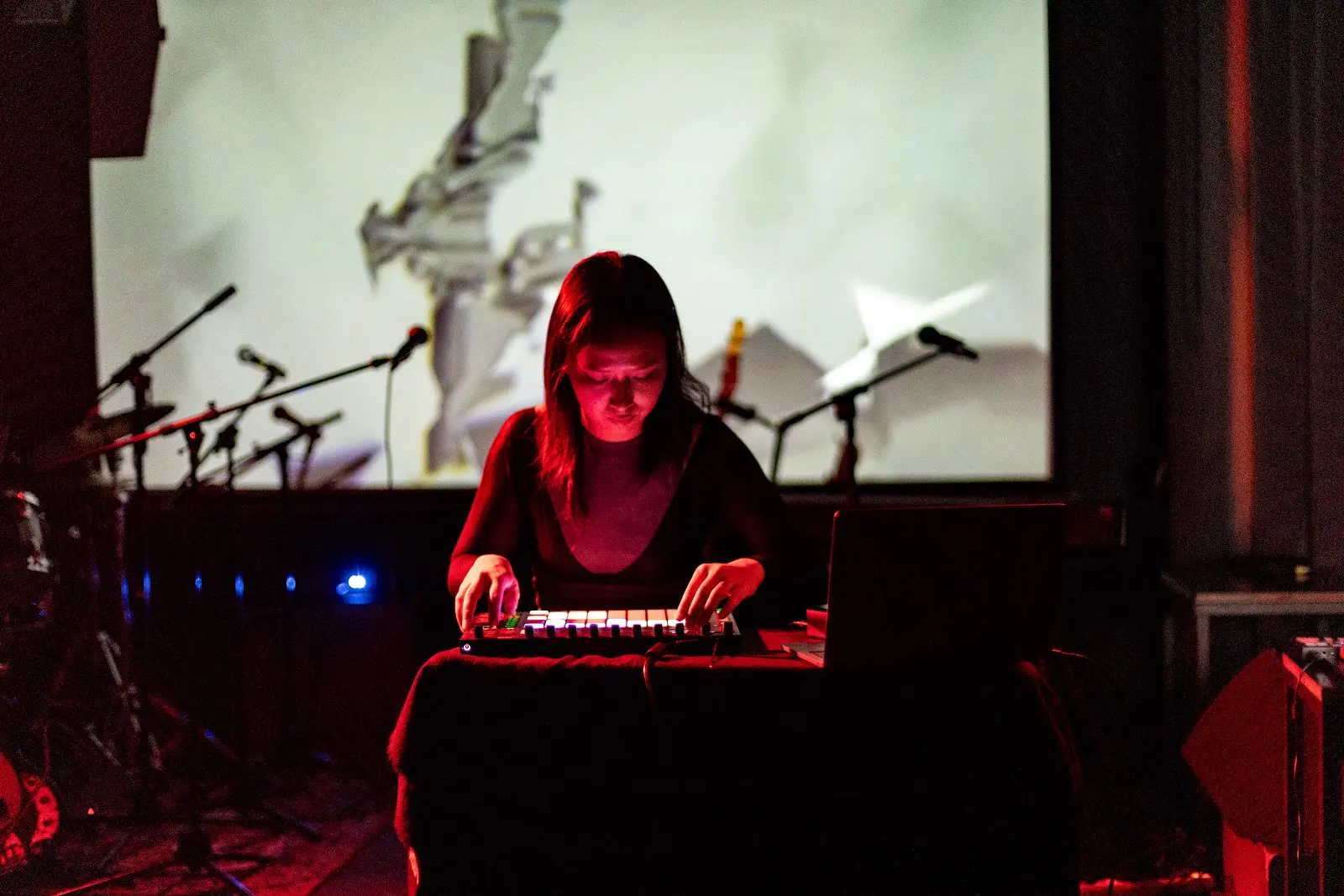 LnHD performing a live set, seated with electronic machines